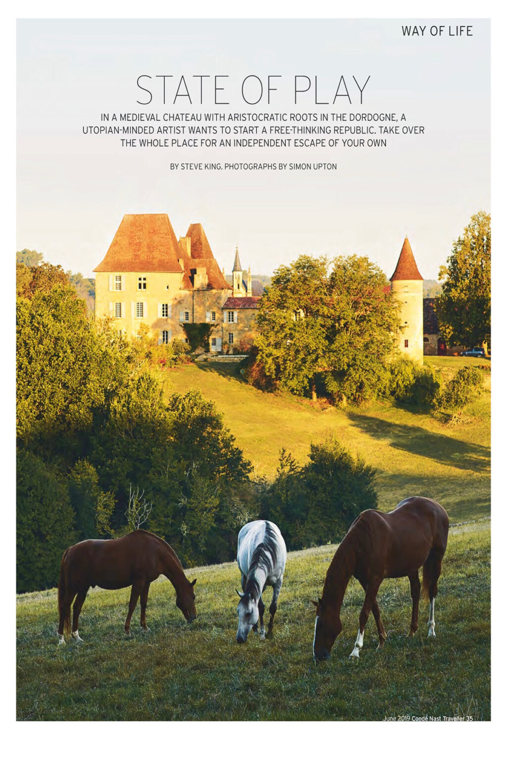 Scenic view of a historic castle with red-roofed towers surrounded by lush greenery, featuring two horses grazing in the foreground under a clear blue sky. | Only on SopranoVillas
