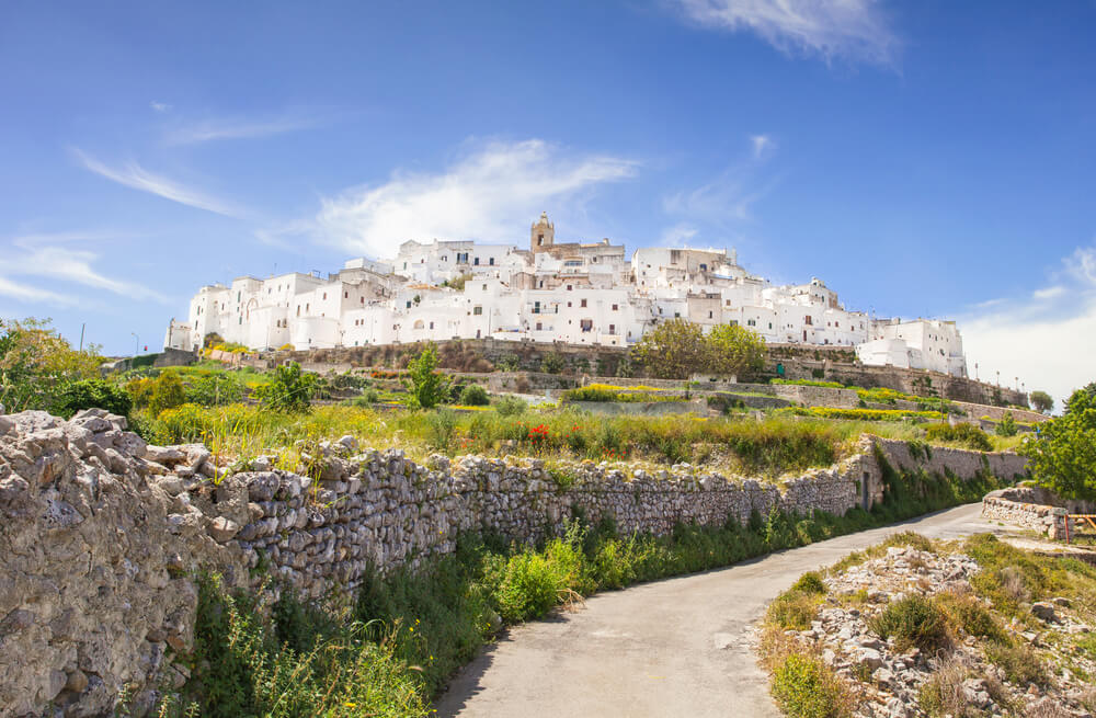Whitewashed buildings of Ostuni above stone walls and countryside
