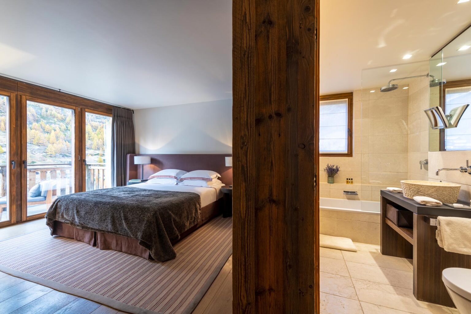 Spacious hotel room featuring a comfortable king-size bed, large windows with scenic views, and an elegant ensuite bathroom with modern fixtures. Ideal for a relaxing getaway. | Only on SopranoVillas