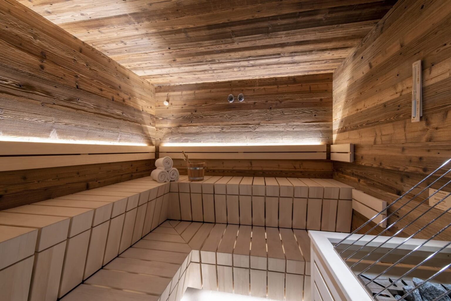 Interior view of a modern wooden sauna featuring natural wood paneling, minimalist design, and ambient lighting for a relaxing atmosphere. | Only on SopranoVillas