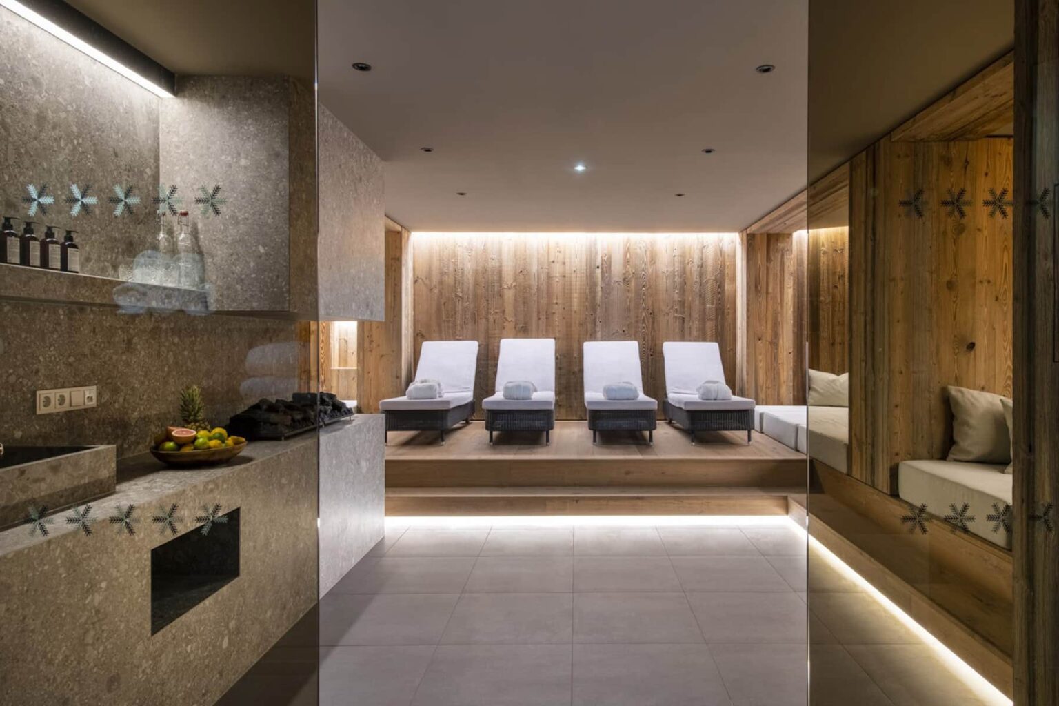Modern spa interior featuring comfortable lounge chairs, soft ambient lighting, and a relaxing atmosphere, ideal for wellness and rejuvenation. | Only on SopranoVillas