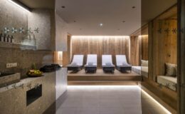 Modern spa interior featuring comfortable lounge chairs, soft ambient lighting, and a relaxing atmosphere, ideal for wellness and rejuvenation.