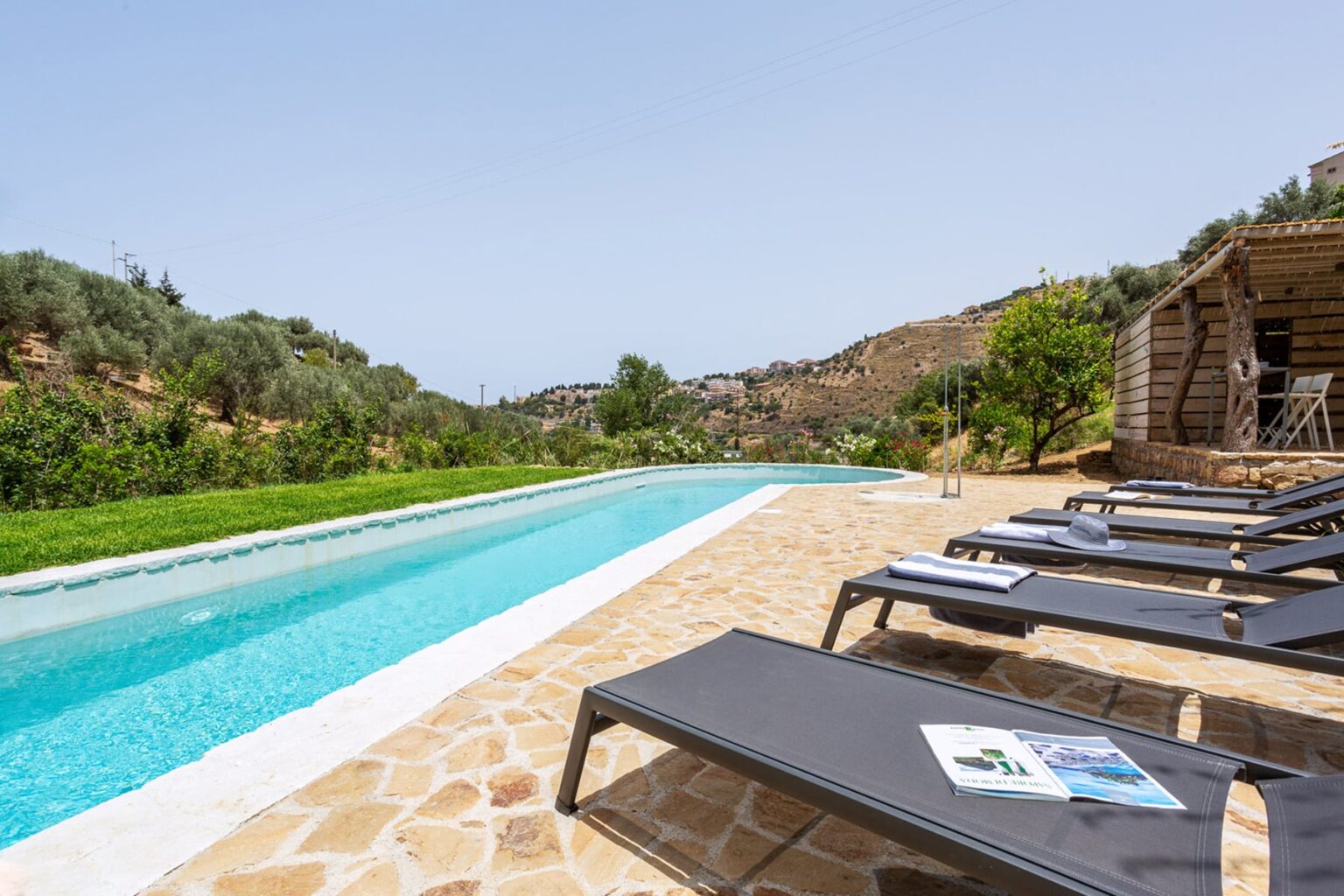 Luxury outdoor pool with sun loungers and scenic hillside views, perfect for relaxation and leisure. | Only on SopranoVillas