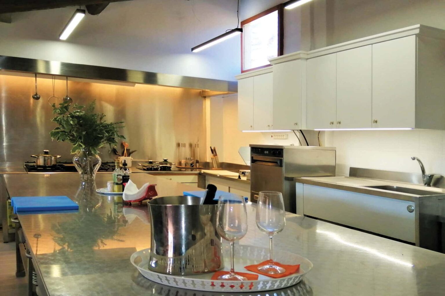 Modern kitchen interior featuring stainless steel appliances, a spacious countertop, and elegant cabinetry, illuminated by natural light. Ideal for cooking and entertaining. | Only on SopranoVillas