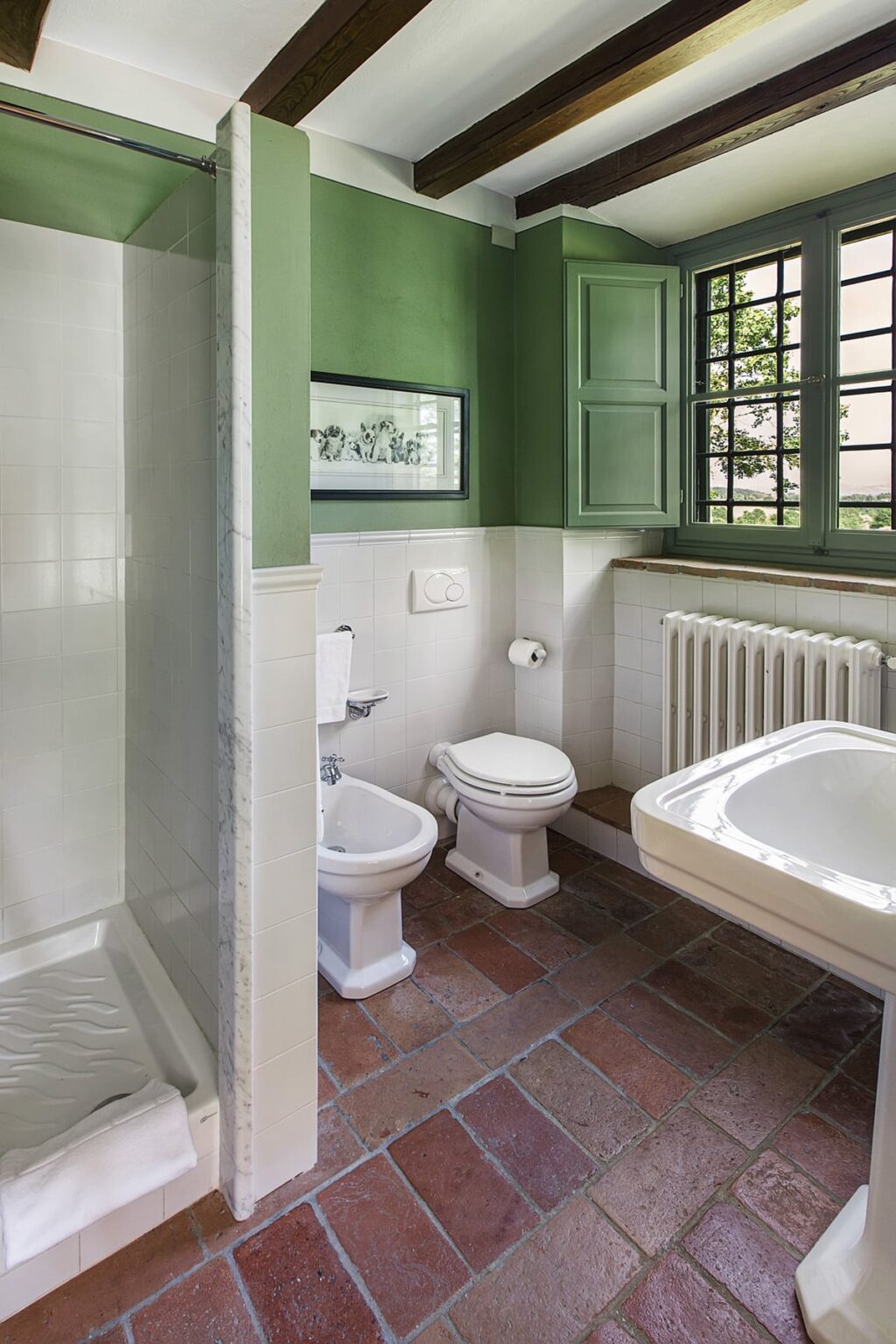 Modern bathroom featuring a green color scheme, a shower area, a bidet, a toilet, and a stylish bathtub, with natural light streaming through windows. | Only on SopranoVillas