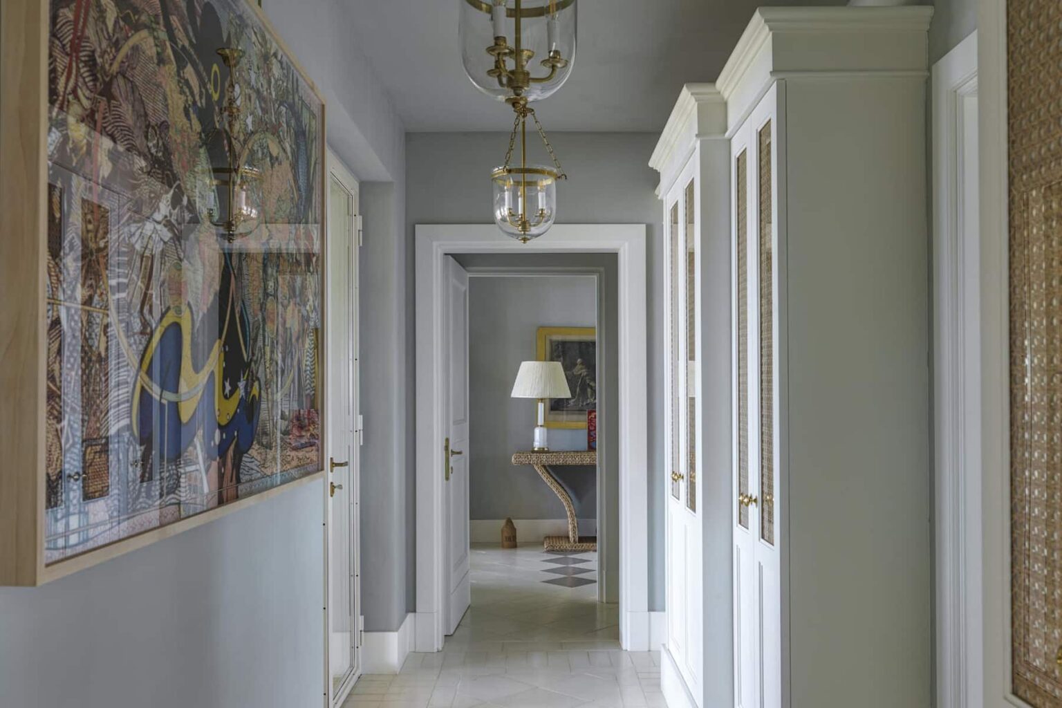 Modern hallway featuring elegant lighting, decorative artwork, and stylish cabinetry, creating a welcoming atmosphere in a contemporary home. | Only on SopranoVillas