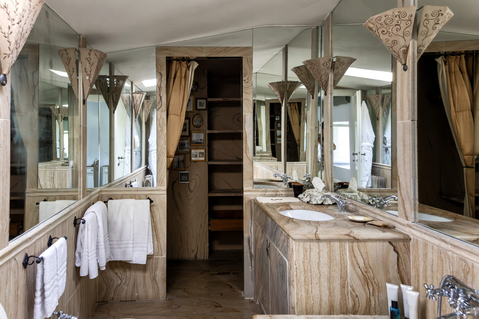 Spacious modern bathroom featuring elegant wooden cabinetry, multiple mirrors, and soft drapes, designed for comfort and style. | Only on SopranoVillas