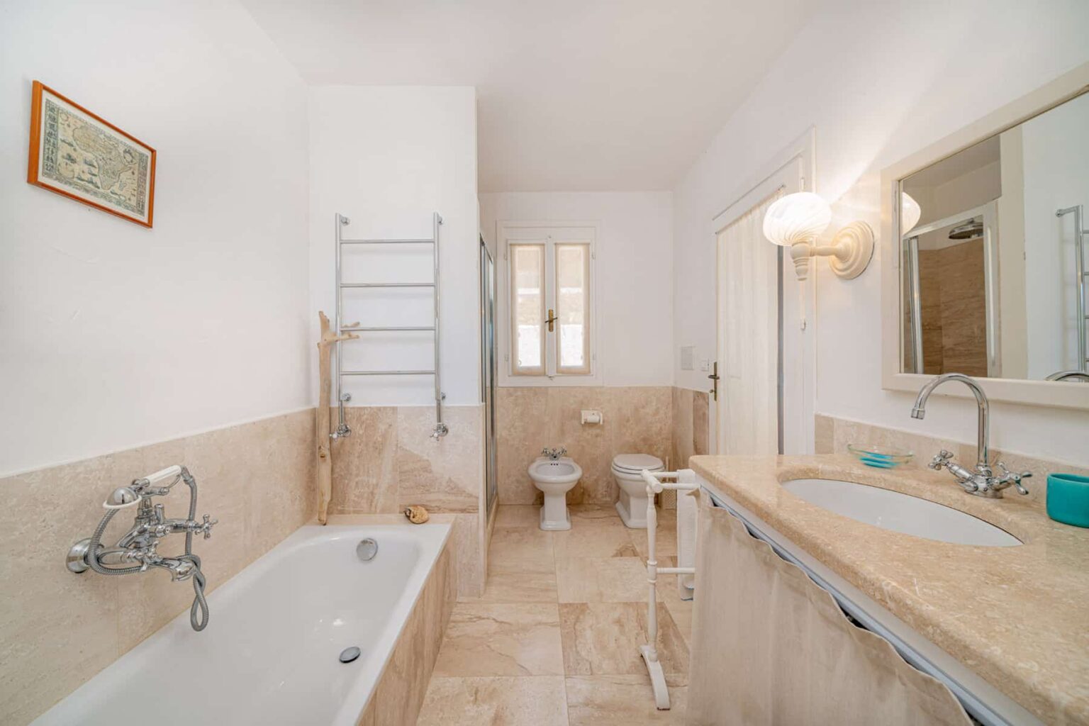 Modern bathroom featuring a spacious tub, elegant fixtures, a stylish vanity with a large mirror, and neutral-toned tiles, creating a bright and inviting atmosphere. | Only on SopranoVillas