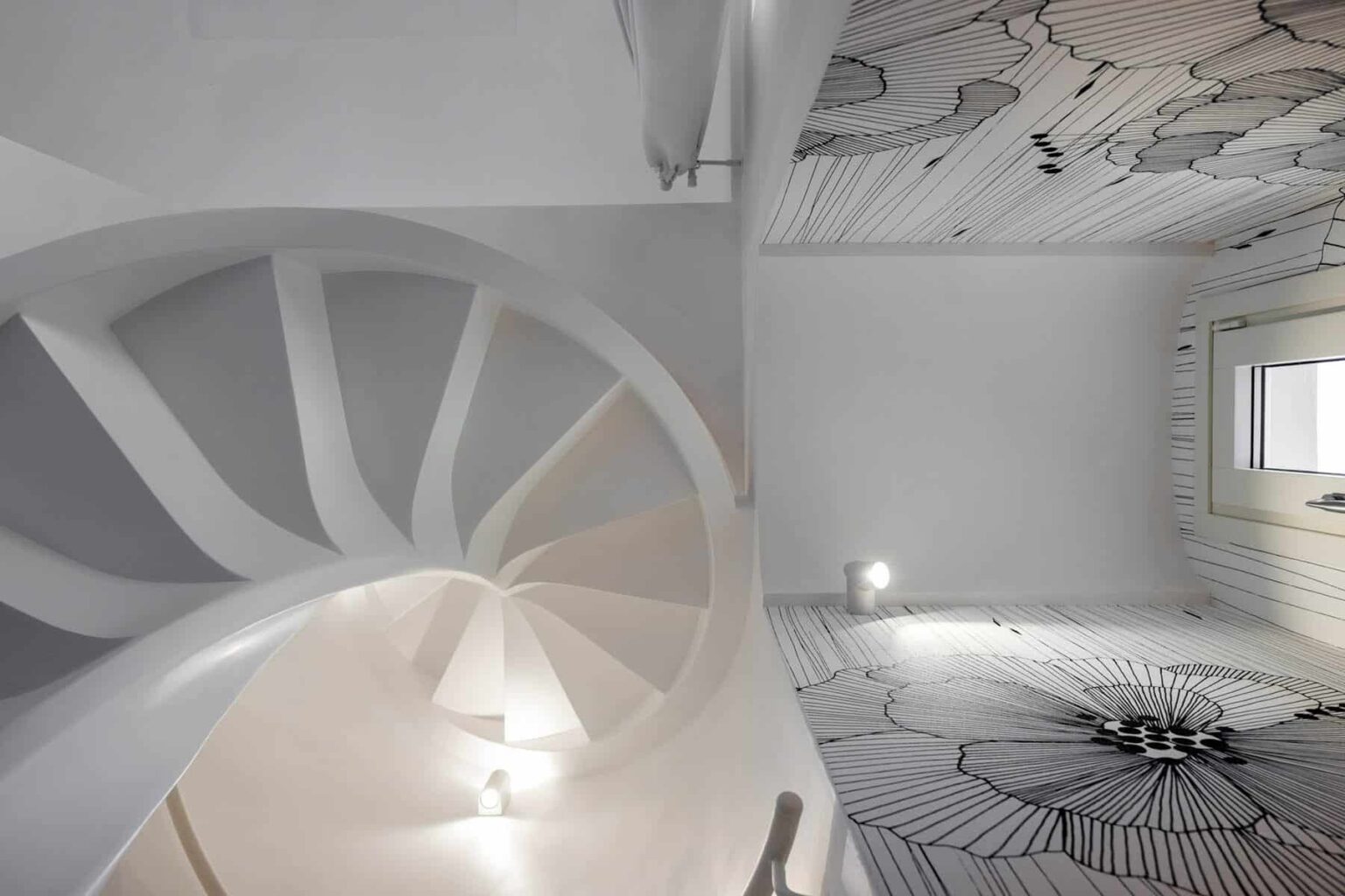 Modern interior design featuring a spiral staircase and artistic ceiling and floor patterns in a bright, minimalist space. | Only on SopranoVillas