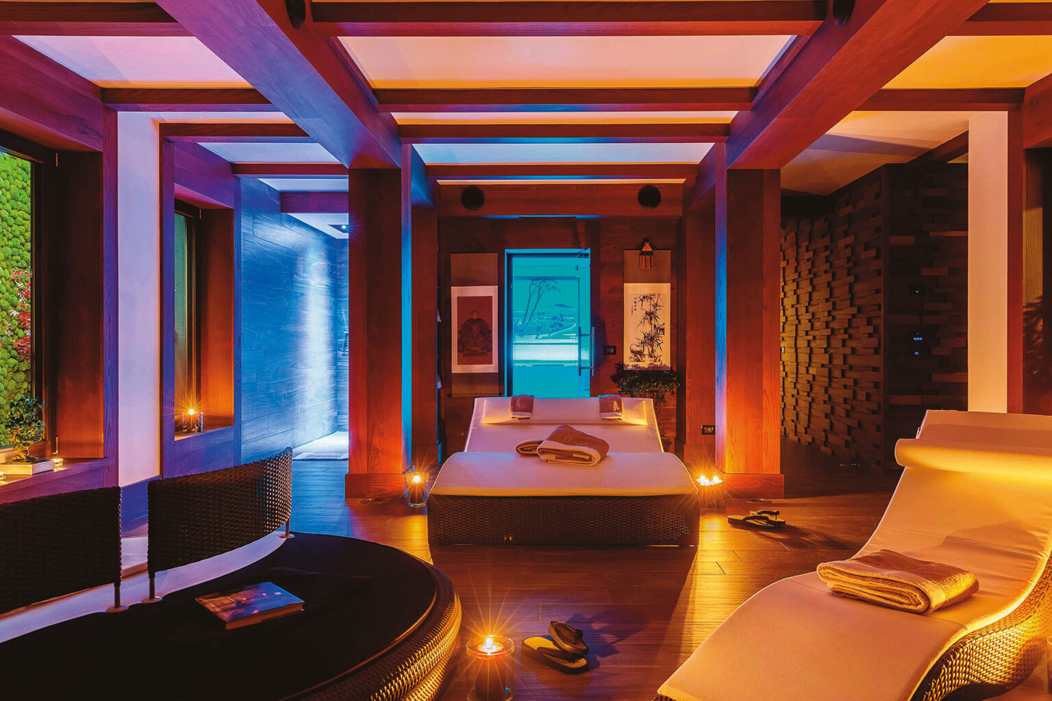 Modern spa interior featuring a serene atmosphere with ambient lighting, a comfortable bed, and lounge chairs, designed for relaxation and wellness. | Only on SopranoVillas