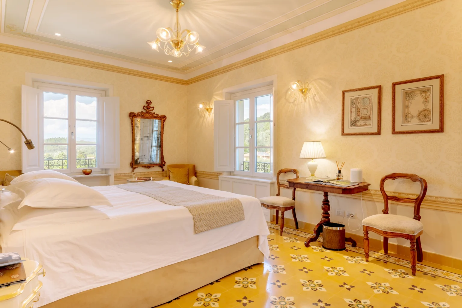 Elegant bedroom in a luxury villa for rent in Italy, featuring a spacious layout, vintage decor, large windows with scenic views, and stylish furnishings. Ideal for a relaxing getaway. | Only on SopranoVillas