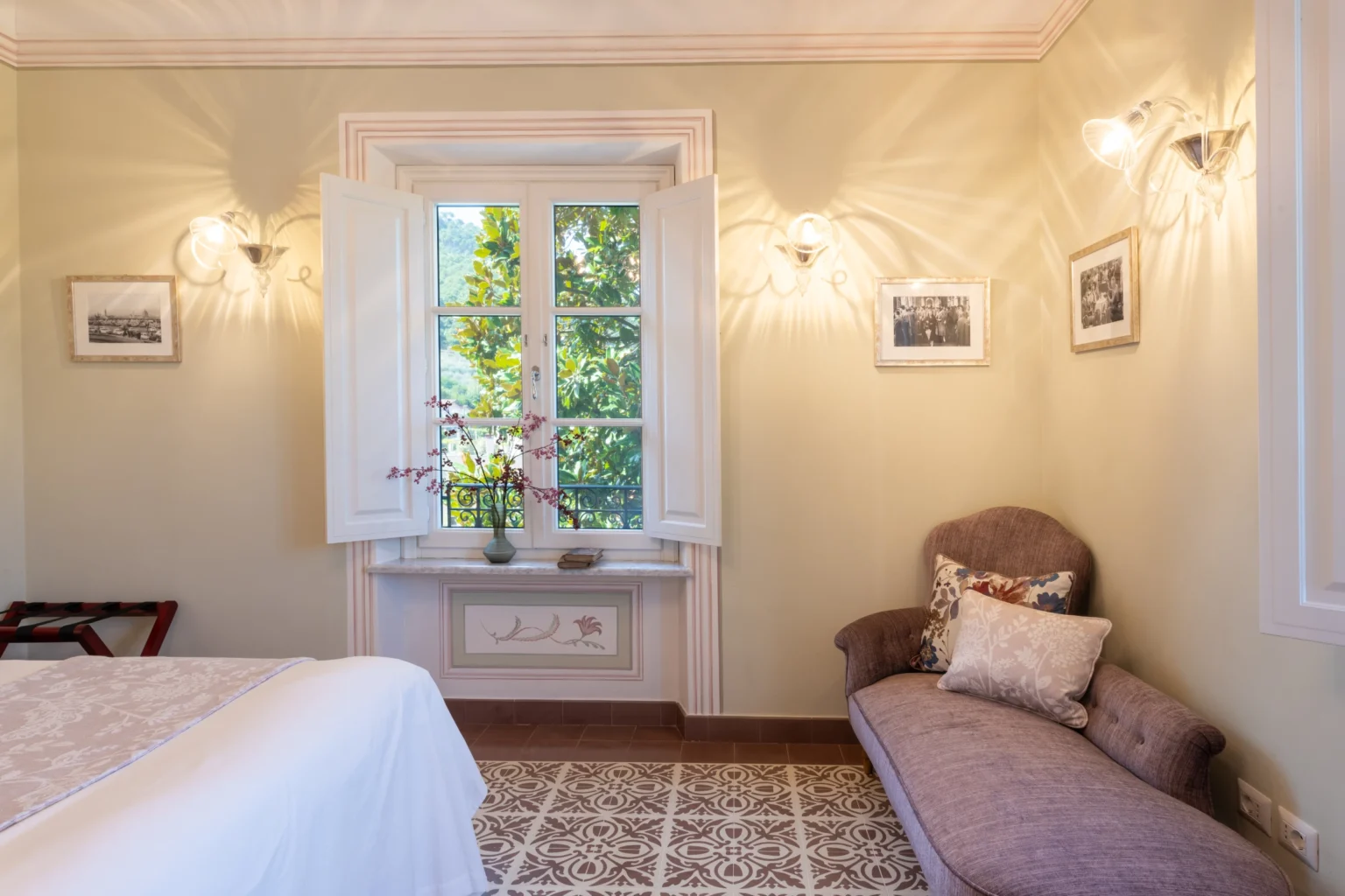 Luxurious bedroom interior in a villa for rent in Italy, featuring elegant decor, natural light from a large window, and tasteful furnishings for a comfortable stay. | Only on SopranoVillas