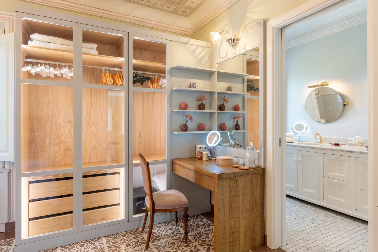 Luxury villa interior featuring an elegantly designed dressing area with a spacious closet and a stylish vanity, complemented by a modern bathroom, ideal for upscale rentals in Italy. | Only on SopranoVillas