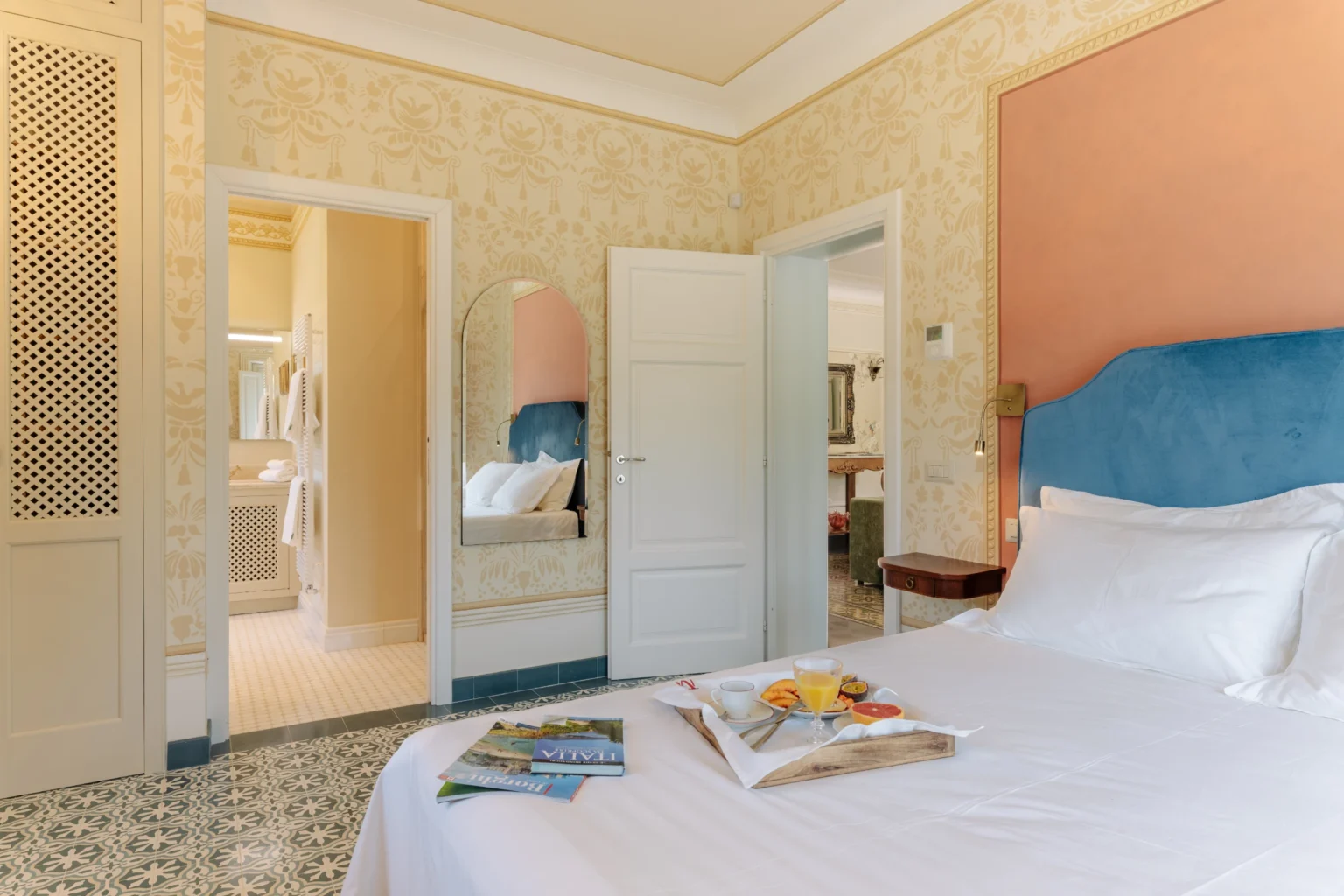 Luxurious bedroom interior in a villa in Italy, featuring elegant decor, a comfortable bed with plush linens, and a stylish ensuite bathroom. Ideal for travelers seeking upscale accommodations. | Only on SopranoVillas