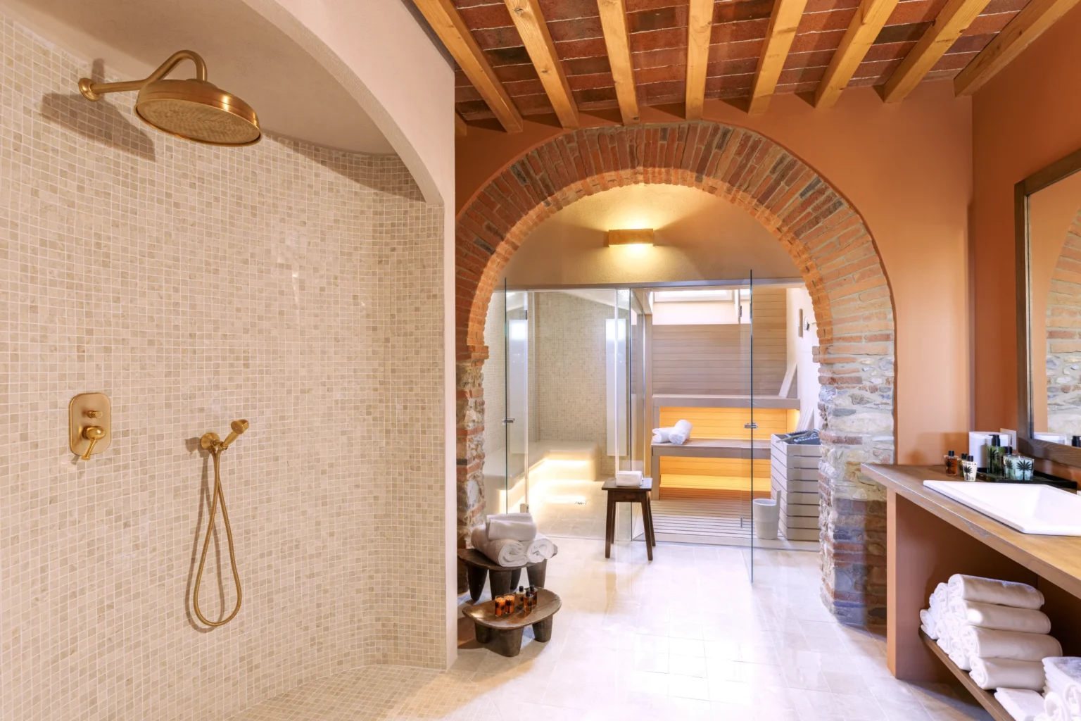 Luxury villa bathroom in Italy featuring a spacious walk-in shower, elegant fixtures, and a stylish wooden ceiling, perfect for a relaxing getaway. | Only on SopranoVillas