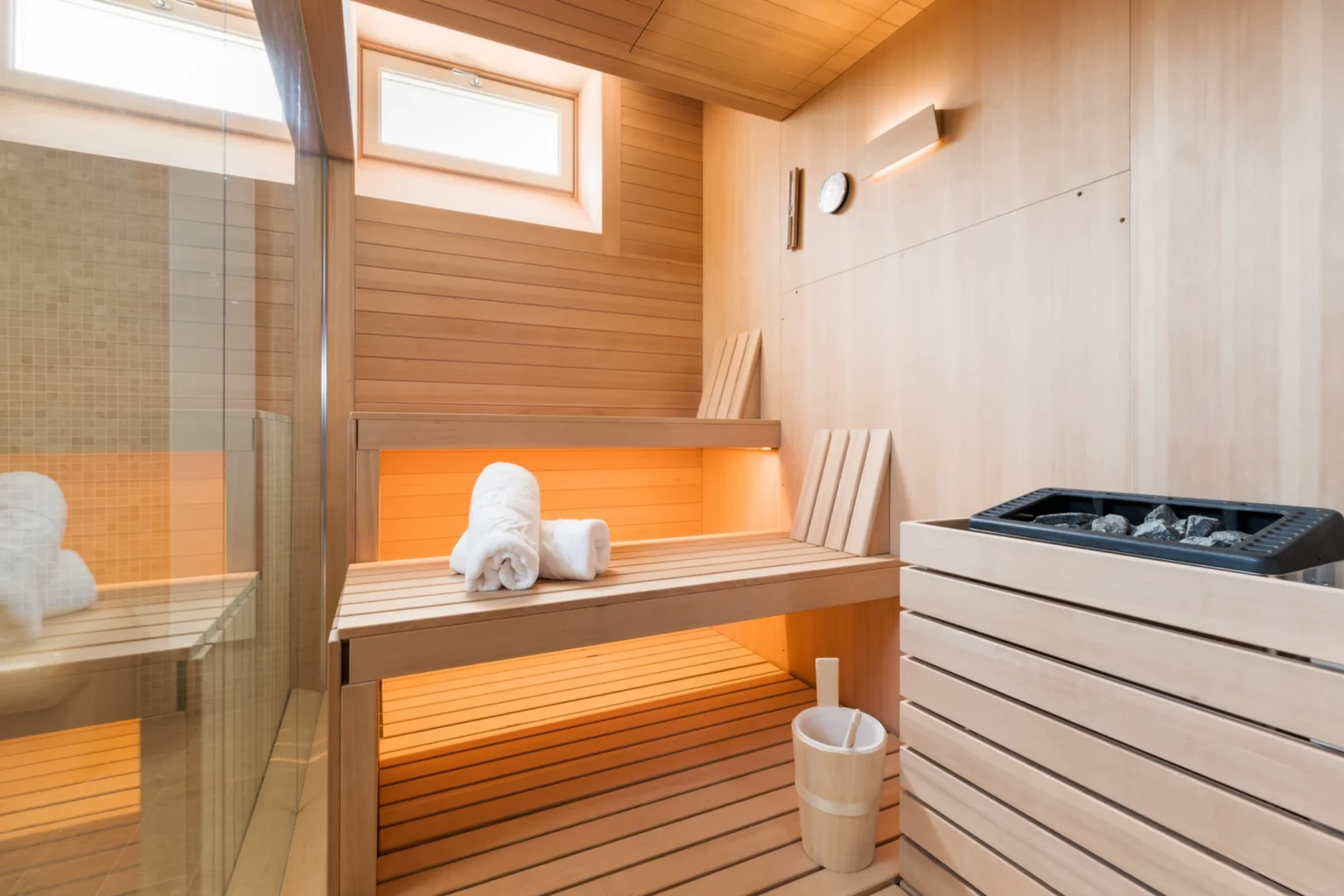 Luxury villa sauna interior with wooden benches, soft lighting, and spa amenities, perfect for relaxation in Italy. | Only on SopranoVillas