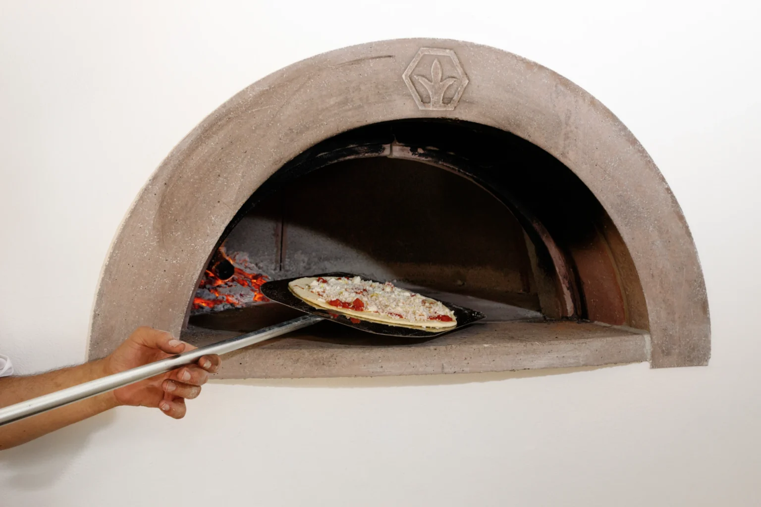 Traditional pizza oven in a luxury villa in Italy, showcasing authentic Italian cooking experiences for guests. Perfect for enjoying gourmet meals during your stay. | Only on SopranoVillas