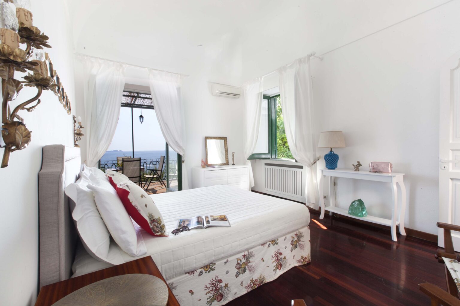 Luxurious bedroom in an Italian villa for rent, featuring elegant decor, large windows with scenic views, and high-quality furnishings for a comfortable stay. | Only on SopranoVillas