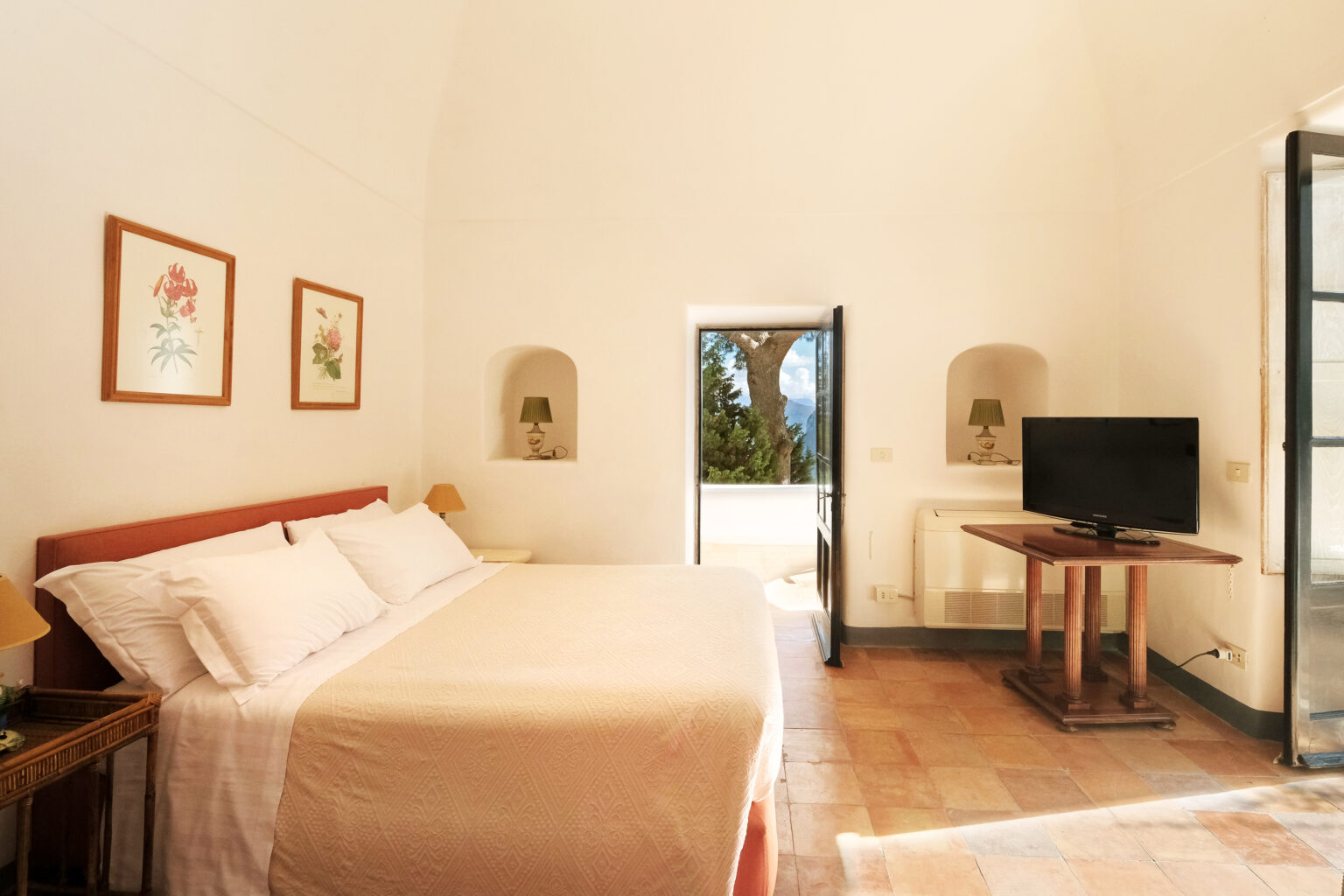Spacious and bright bedroom featuring a king-size bed, wooden furniture, a flat-screen TV, and large windows with scenic views, perfect for a relaxing stay. | Only on SopranoVillas