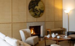Luxurious interior of a villa in Italy featuring a cozy living room with a fireplace, modern furniture, and elegant decor, perfect for a relaxing getaway.