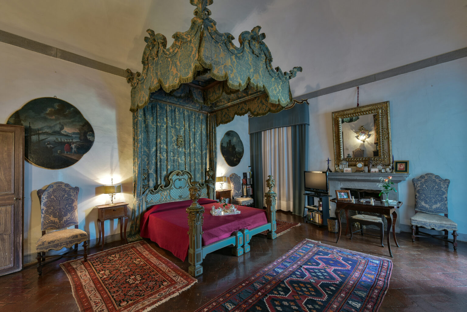 Luxurious vintage bedroom featuring a four-poster bed with ornate canopy, elegant furniture, and rich textiles. The room is adorned with classic artwork, decorative mirrors, and intricate rugs, creating a sophisticated and inviting atmosphere. | Only on SopranoVillas