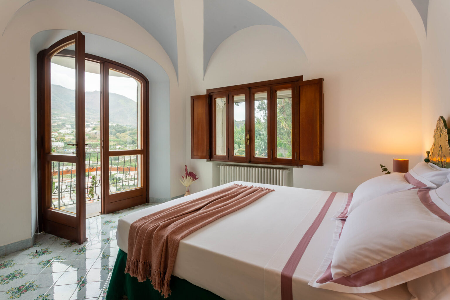 Cozy bedroom with a large bed, elegant decor, and scenic views through open wooden windows, featuring a bright and airy atmosphere in a modern design. | Only on SopranoVillas
