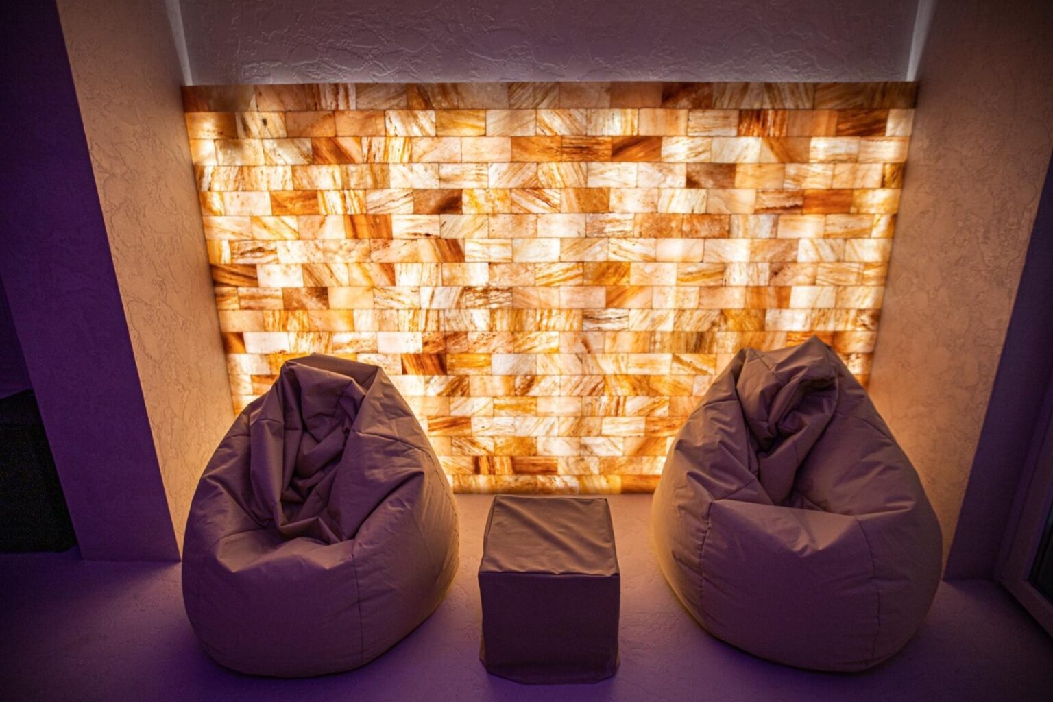 Cozy seating area featuring two bean bags and a stylish illuminated salt wall, creating a relaxing ambiance in a modern interior space. | Only on SopranoVillas