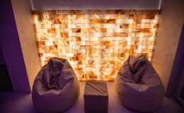 Cozy seating area featuring two bean bags and a stylish illuminated salt wall, creating a relaxing ambiance in a modern interior space.