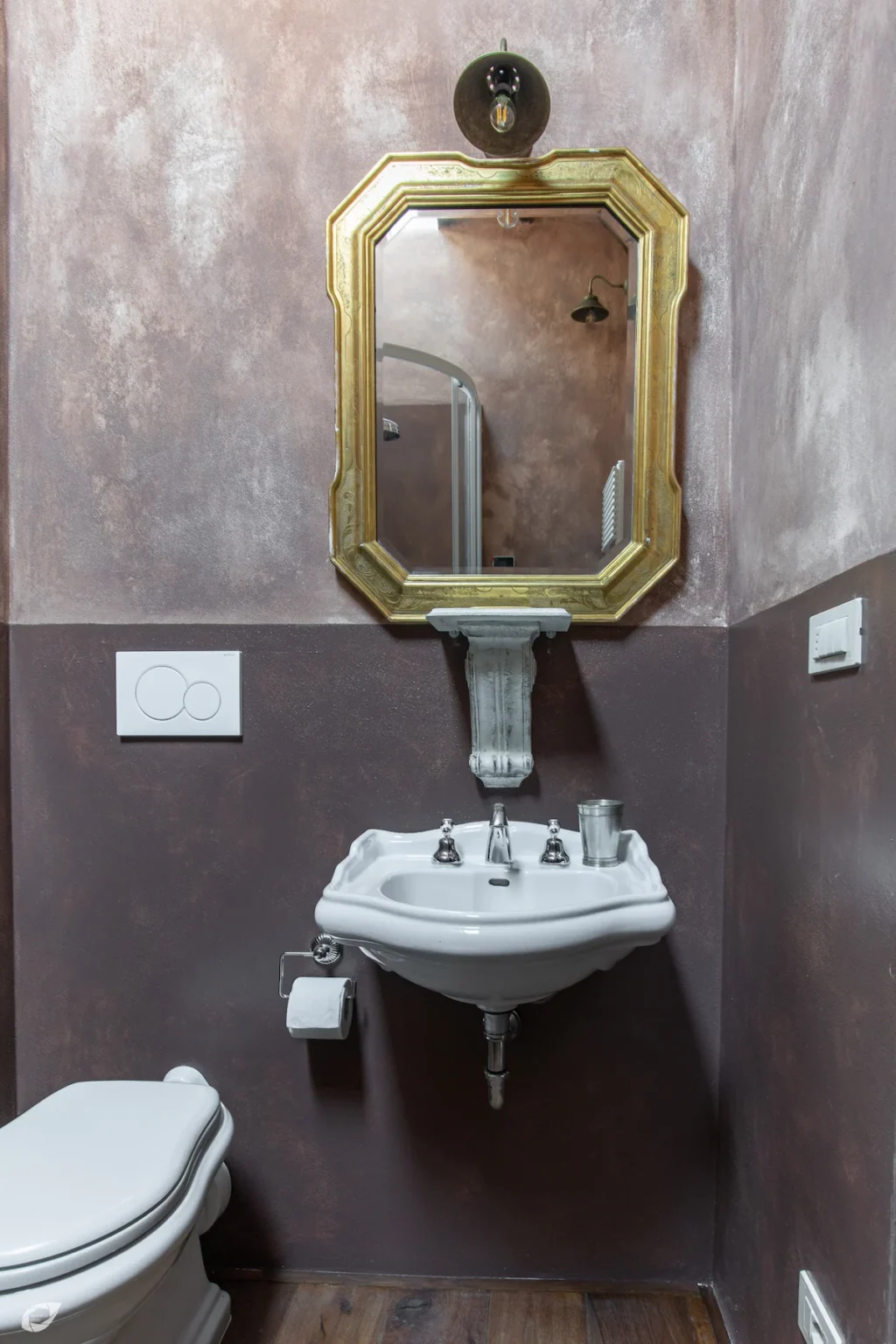 Elegant bathroom design featuring a vintage-style sink, ornate mirror, and modern fixtures against a textured wall. Ideal for showcasing home decor and renovation ideas. | Only on SopranoVillas