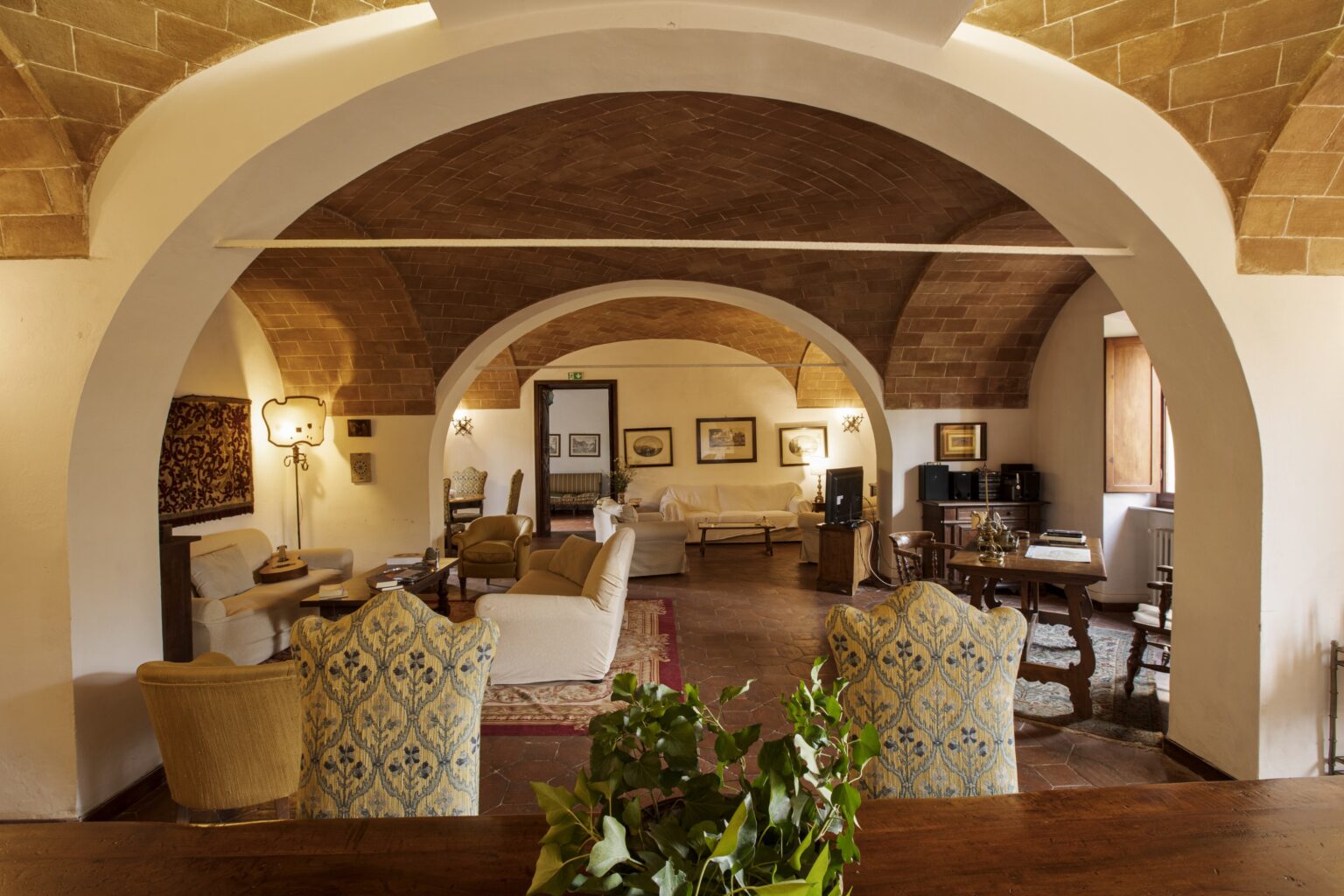 Spacious living area featuring arched ceilings, elegant furniture, and warm lighting, creating a cozy and inviting atmosphere. | Only on SopranoVillas