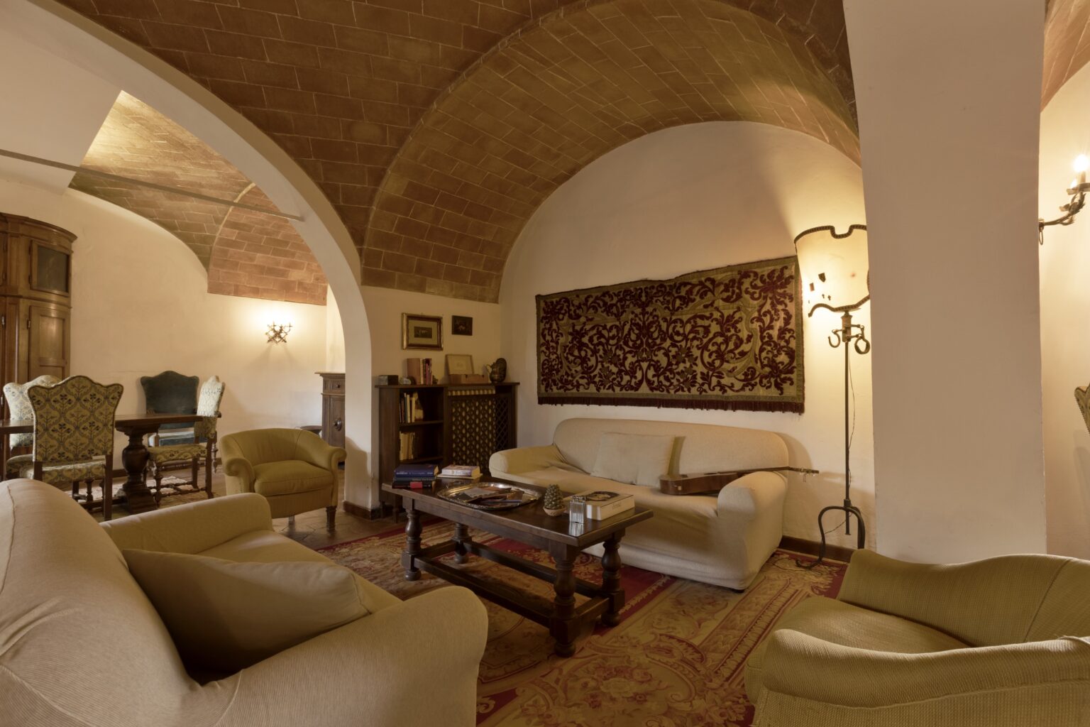 Cozy living room featuring arched ceilings, comfortable seating, and decorative wall art, creating an inviting atmosphere for relaxation and gatherings. | Only on SopranoVillas