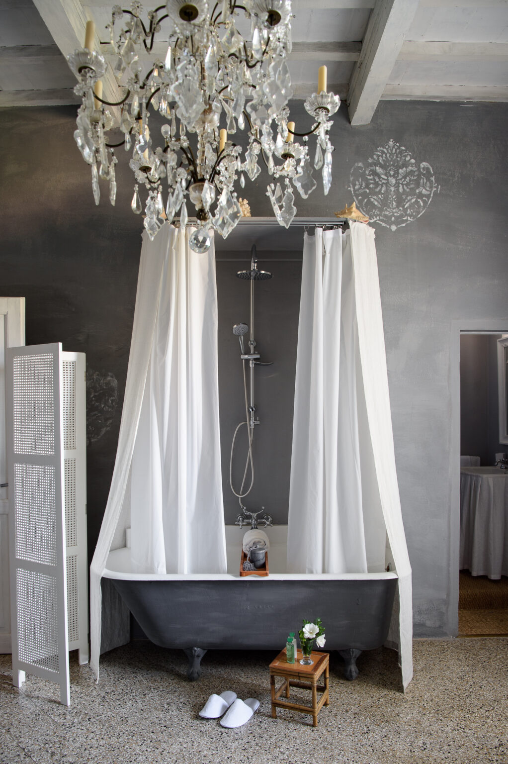 Modern bathroom design featuring a sleek shower area with white curtains, a contemporary showerhead, and a minimalist aesthetic against a dark gray wall. | Only on SopranoVillas