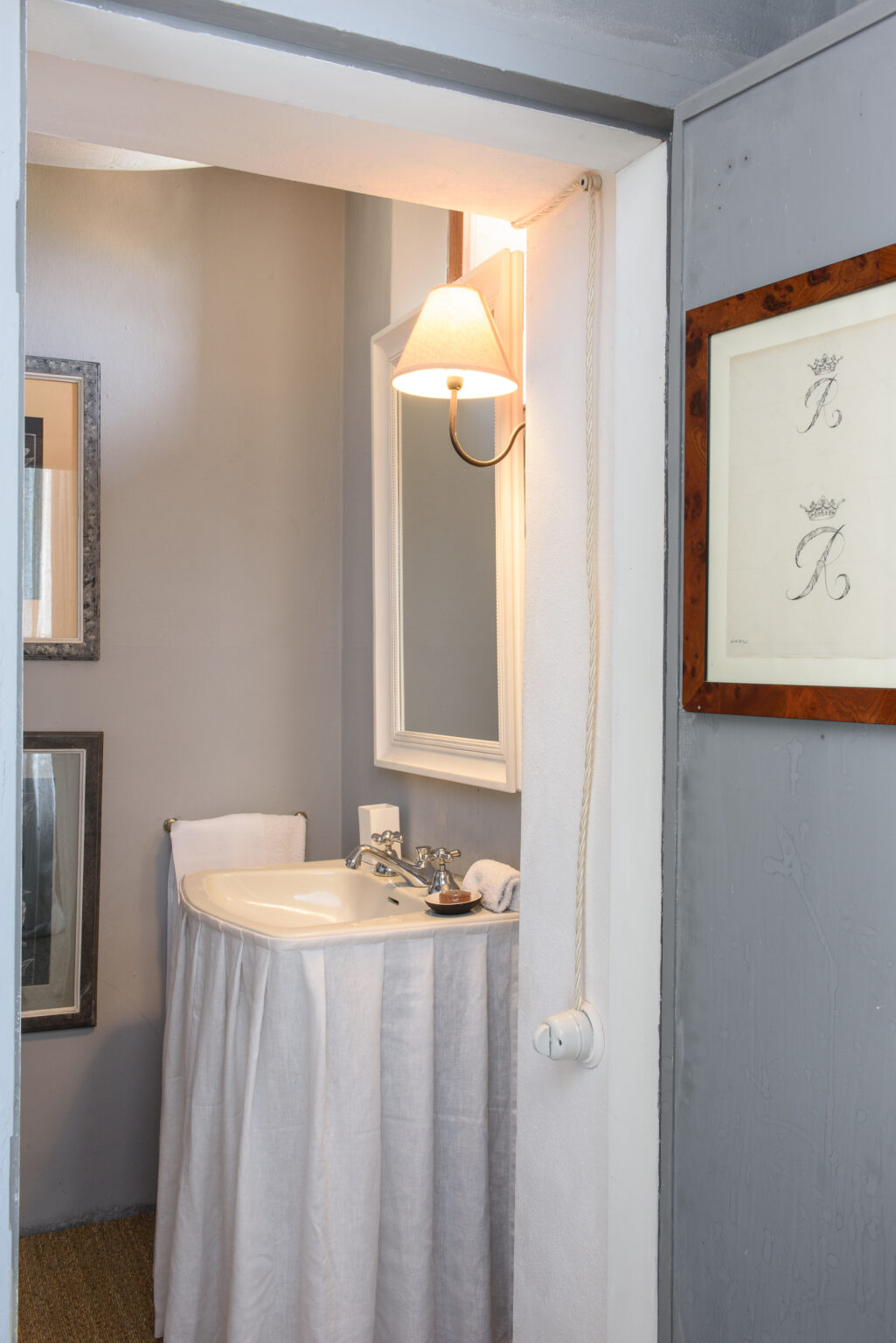 Modern bathroom interior featuring a white sink, elegant wall mirrors, soft lighting, and a neutral gray color scheme, ideal for home decor inspiration. | Only on SopranoVillas