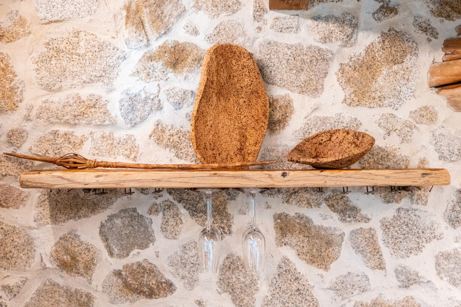 Rustic wooden shelf displaying three natural wooden bowls against a textured stone wall, showcasing artisanal craftsmanship and natural materials. | Only on SopranoVillas