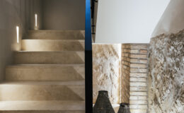 Modern staircase with soft lighting and textured stone walls, showcasing a blend of contemporary design and natural materials. The image features illuminated steps leading to a minimalist space, emphasizing the aesthetic appeal of the architectural elements.