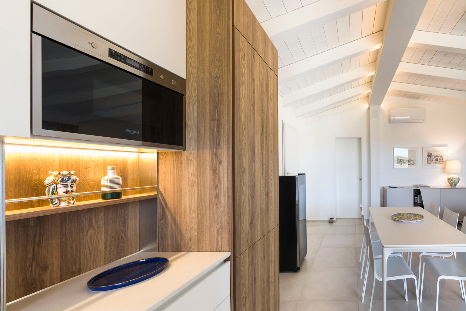 Modern kitchen interior featuring sleek cabinetry, built-in appliances, and a spacious dining area with minimalist decor and natural light. | Only on SopranoVillas