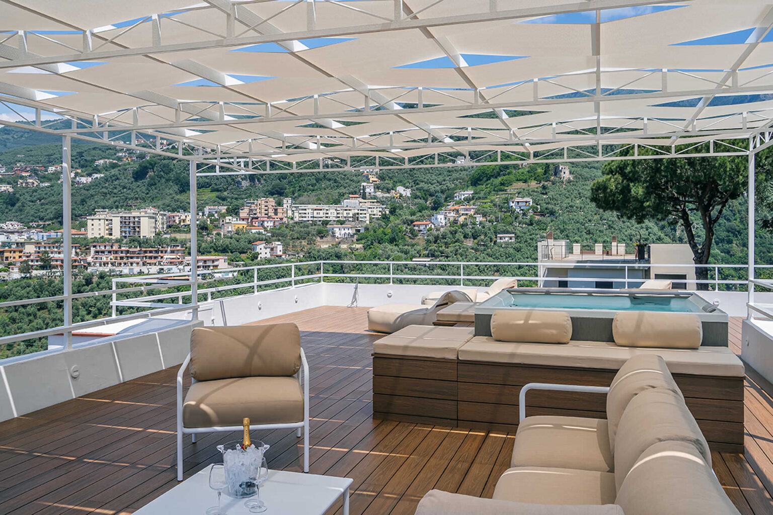 Luxury rooftop terrace with comfortable seating, a relaxing hot tub, and stunning mountain views, perfect for outdoor entertaining and leisure. | Only on SopranoVillas