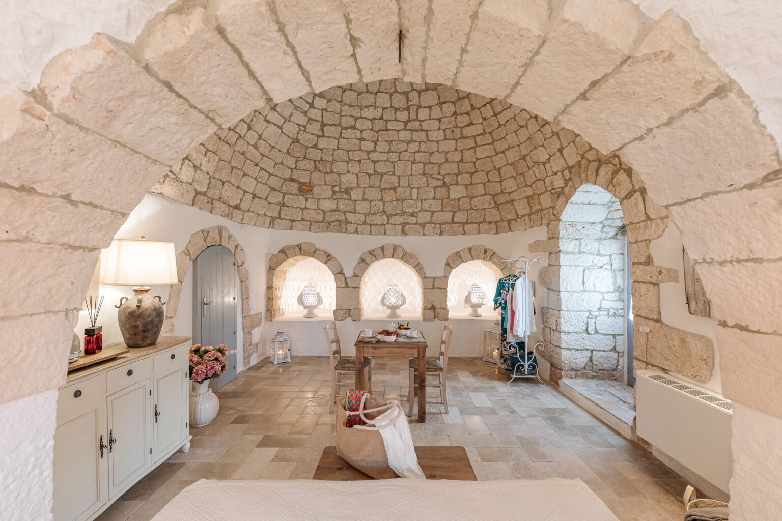 Interior of a beautifully designed stone room featuring an arched ceiling, natural light, and elegant furnishings, showcasing a blend of rustic charm and modern decor. | Only on SopranoVillas