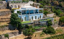 Modern hillside villa with expansive terraces and lush landscaping, overlooking scenic views. Ideal for luxury living and outdoor entertaining.