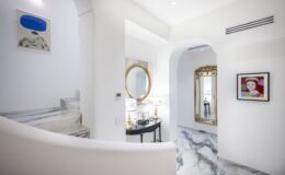 Elegant interior of a luxury villa in Italy featuring marble floors, stylish decor, and ample natural light, ideal for vacation rentals.