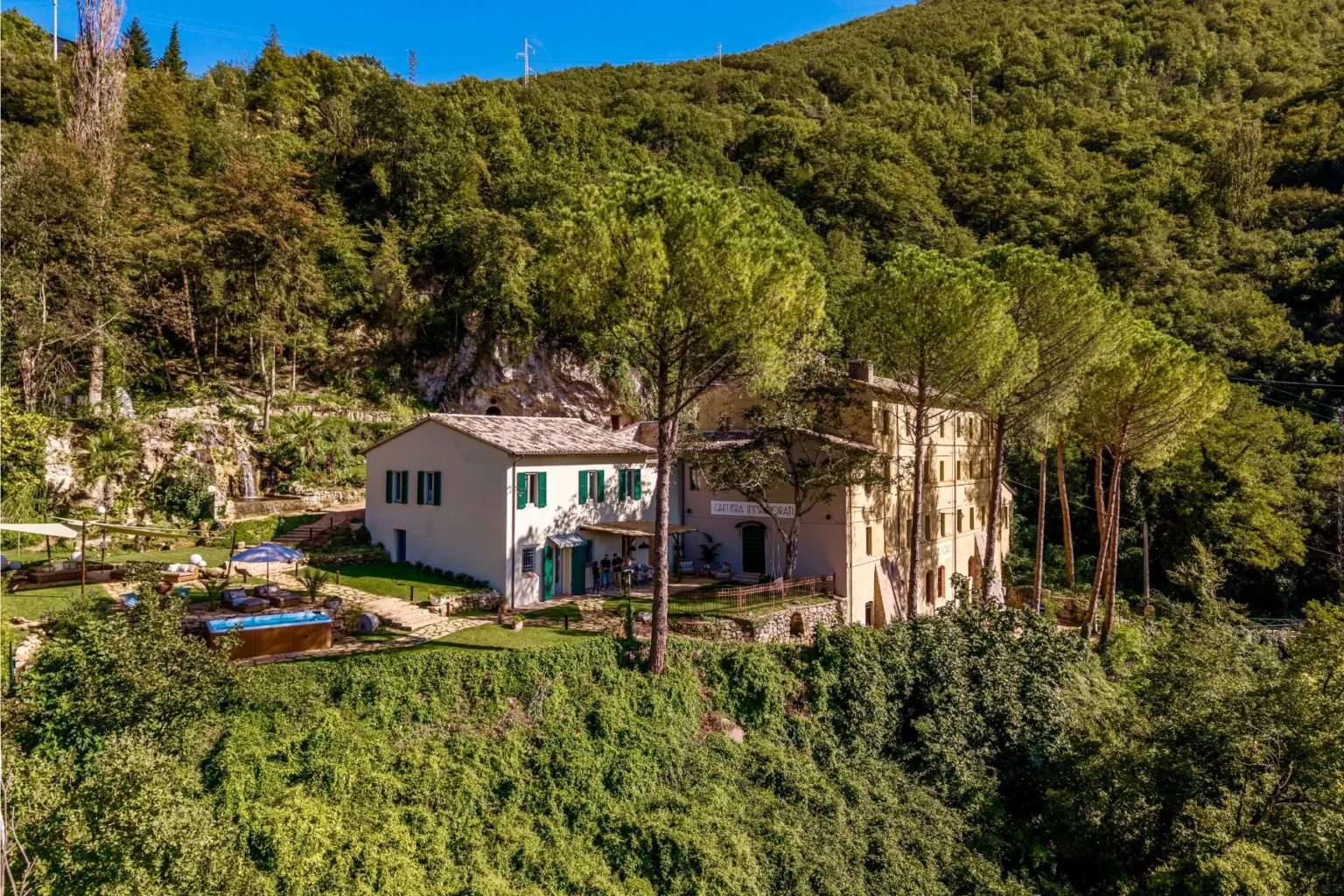 Charming countryside villa surrounded by lush greenery, featuring a spacious garden, swimming pool, and beautiful mountain views, ideal for a relaxing getaway. | Only on SopranoVillas