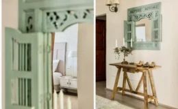 Decorative interior featuring a vintage green mirror with shutter details, a rustic wooden table with decorative items, and soft lighting in a cozy living space.