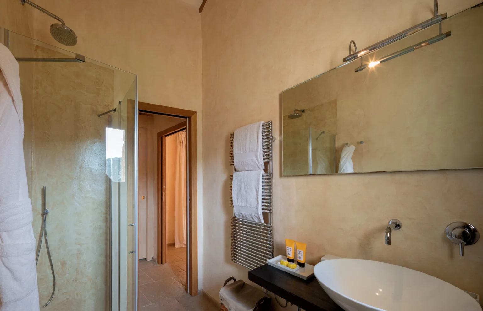 Luxury villa bathroom in Italy featuring modern design, spacious shower, elegant sink, and stylish decor, ideal for a relaxing getaway. | Only on SopranoVillas
