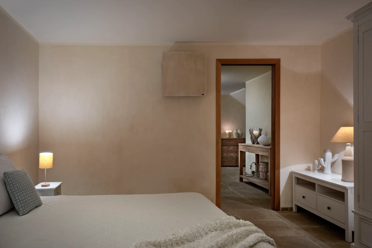 Luxury villa bedroom in Italy featuring elegant decor, soft lighting, and an inviting atmosphere, perfect for a relaxing getaway. | Only on SopranoVillas