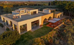Modern luxury home with expansive outdoor space, surrounded by lush greenery and scenic views, showcasing contemporary architecture and stylish design elements.