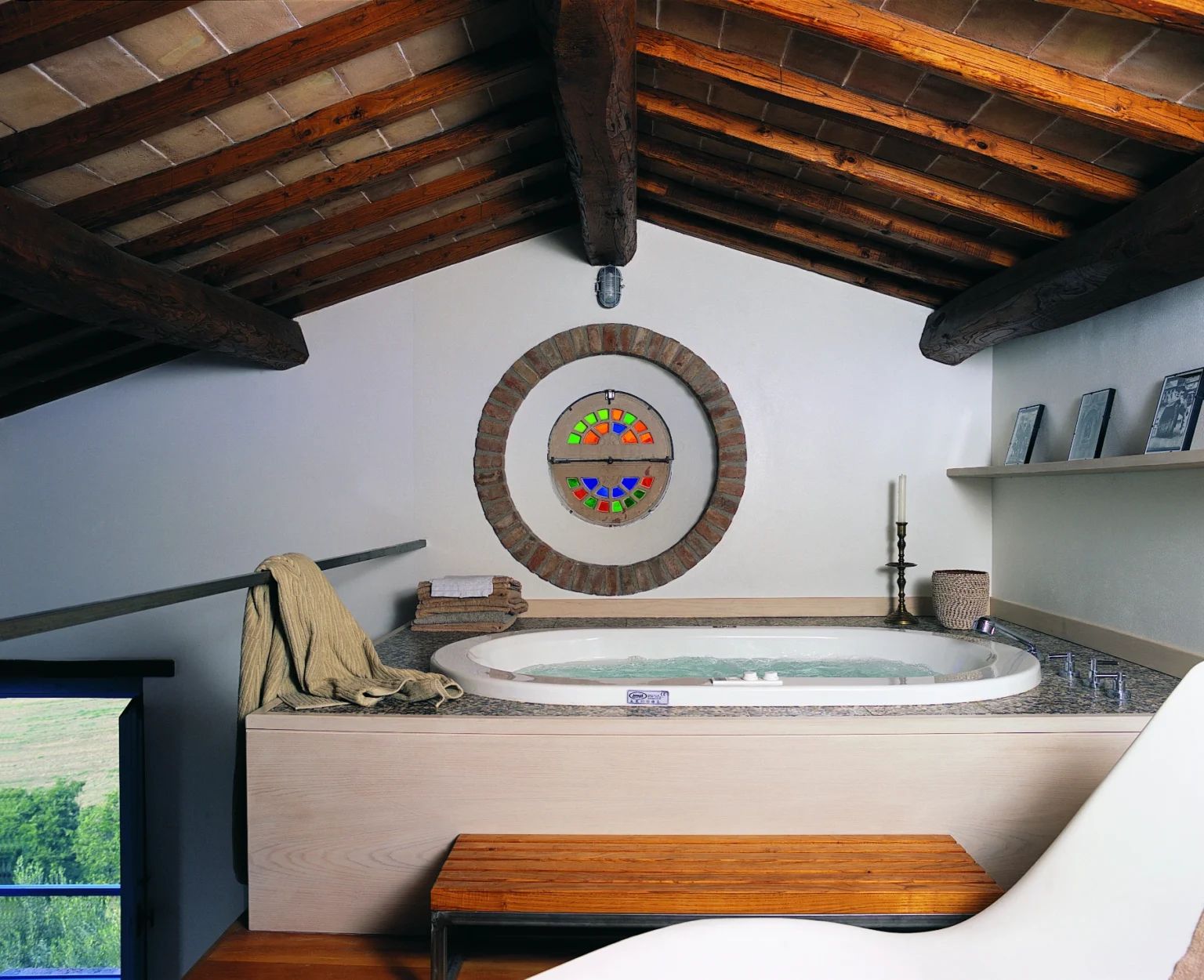 Modern spa bathroom with a circular hot tub, wooden beams, and decorative wall art, creating a relaxing atmosphere. | Only on SopranoVillas