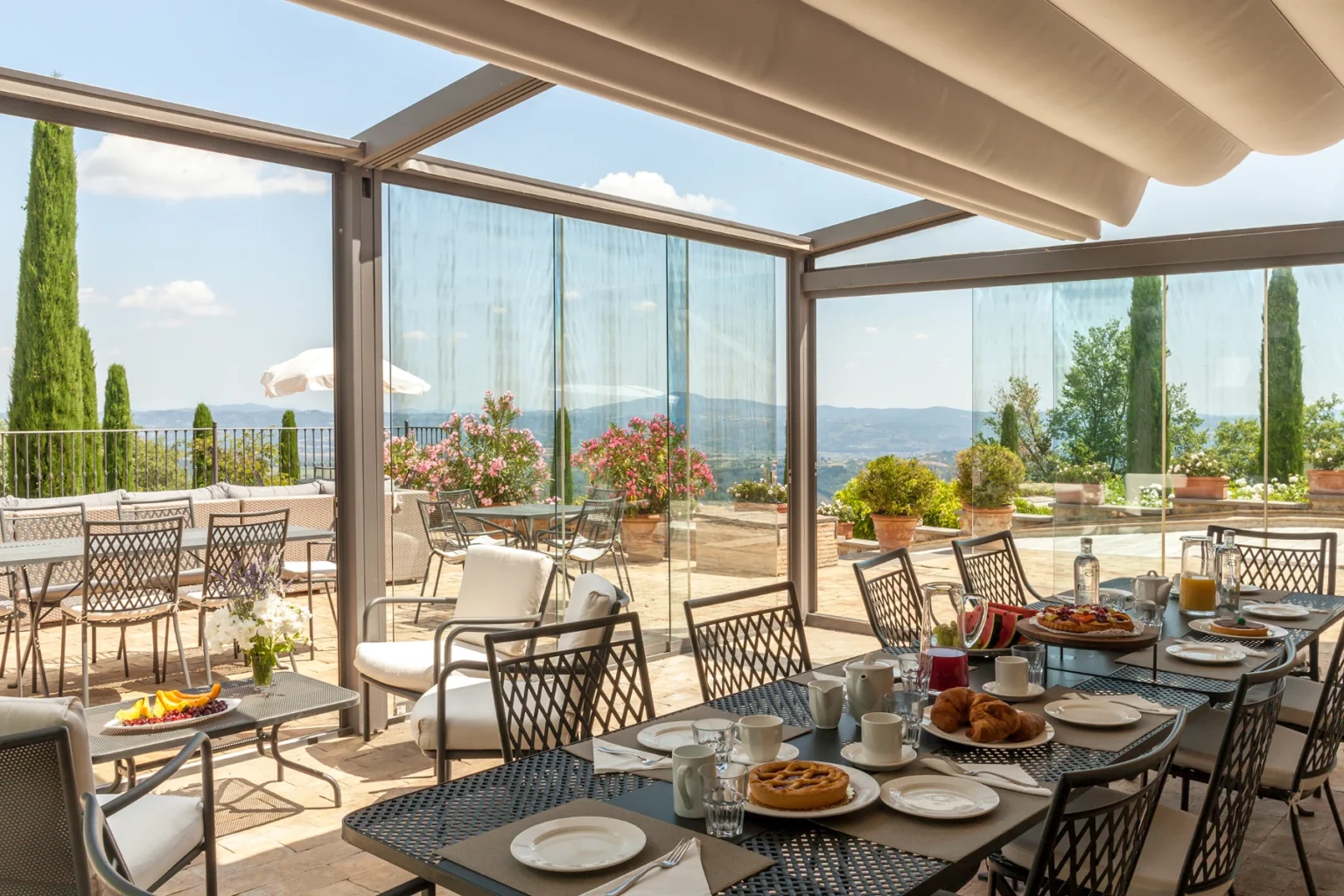 Bisenzio_Historic_Tower_Glass_Enclosed_Dining_Terrace.webp | Only on SopranoVillas