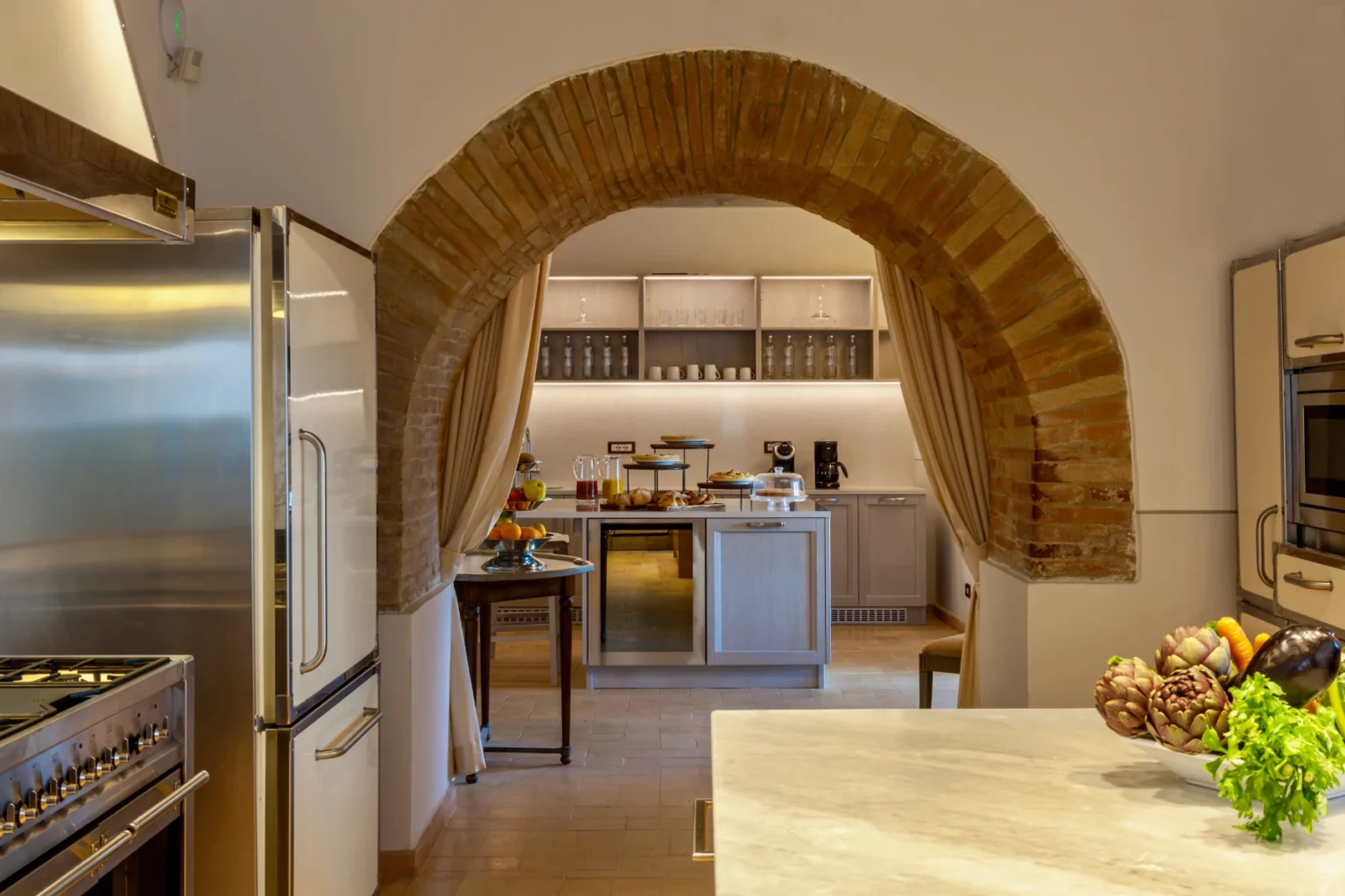 Bisenzio_Historic_Tower_Spacious_Kitchen_Brick_Archway_Breakfast_Area.webp | Only on SopranoVillas
