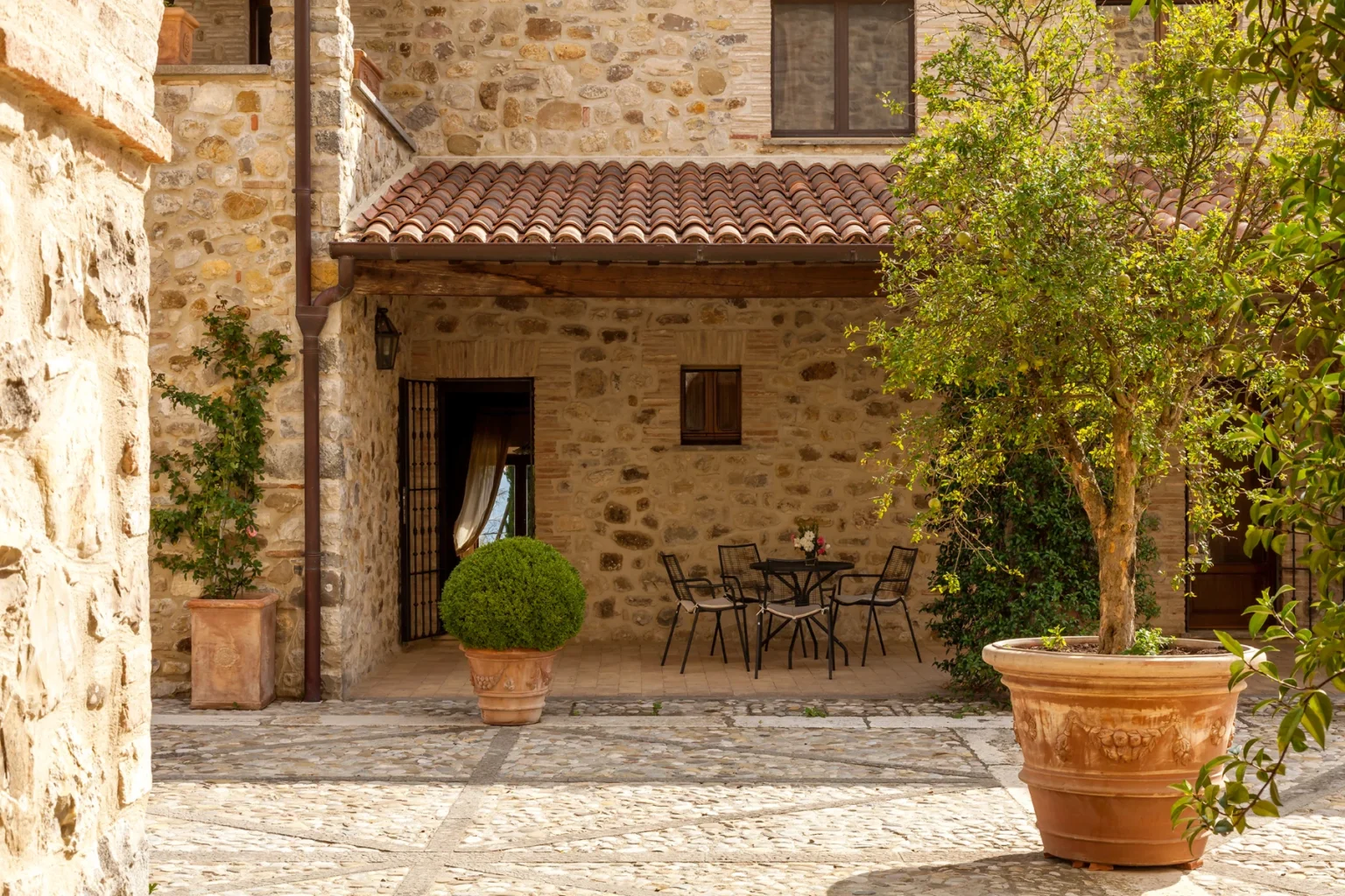 Bisenzio_Historic_Tower_Stone_Courtyard_Outdoor_Seating.webp | Only on SopranoVillas