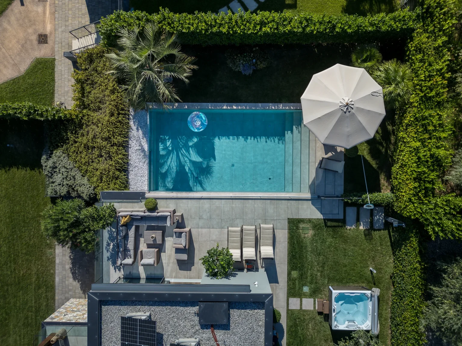 Overhead view of the pool, sun loungers, outdoor seating and hot tub. | Only on SopranoVillas